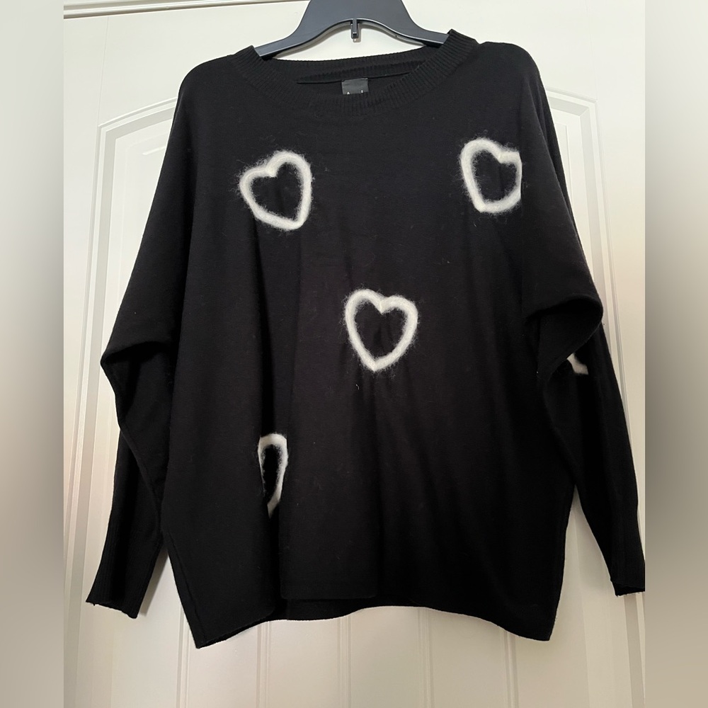 Aaeda Sweater with heart designs on front and sleeve.